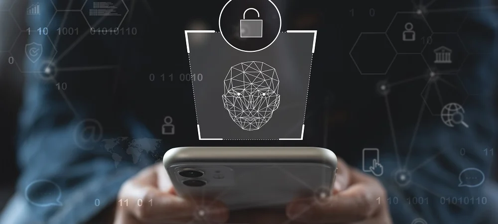 Person holding a smartphone with a digital lock and facial recognition overlay, representing identity verification and biometric authentication in identity intelligence.