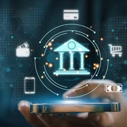 Hand holding a smartphone with holographic icons of a bank, currency, and digital finance elements, symbolizing mobile banking security