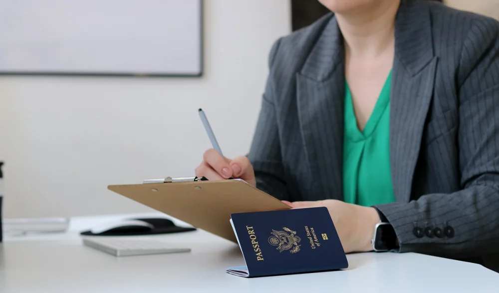 Banker reviewing passport and documents for customer identity verification as part of KYC compliance