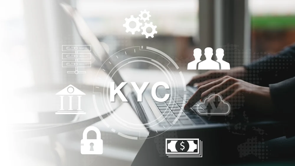 Hands typing on a laptop surrounded by KYC and customer verification icons, representing digital identity checks for financial institutions