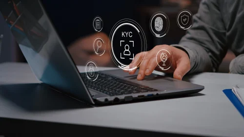Person using a laptop surrounded by virtual KYC icons, representing online identity verification and secure onboarding in banking