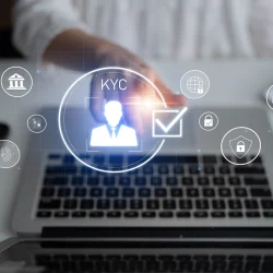 Digital interface showing KYC verification icons on a laptop screen, symbolizing automated KYC verification and data security