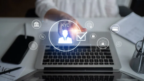 Digital interface showing KYC verification icons on a laptop screen, symbolizing automated KYC verification and data security