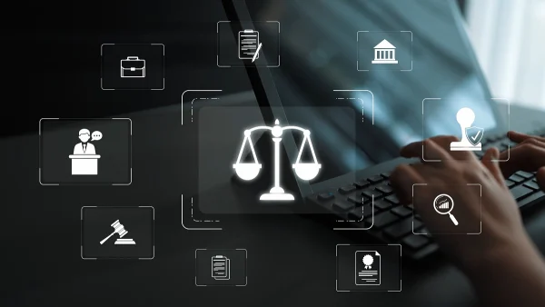 Hands typing on a laptop with digital compliance and legal icons overlaid, symbolizing KYC governance, audit trails, and regulatory alignment