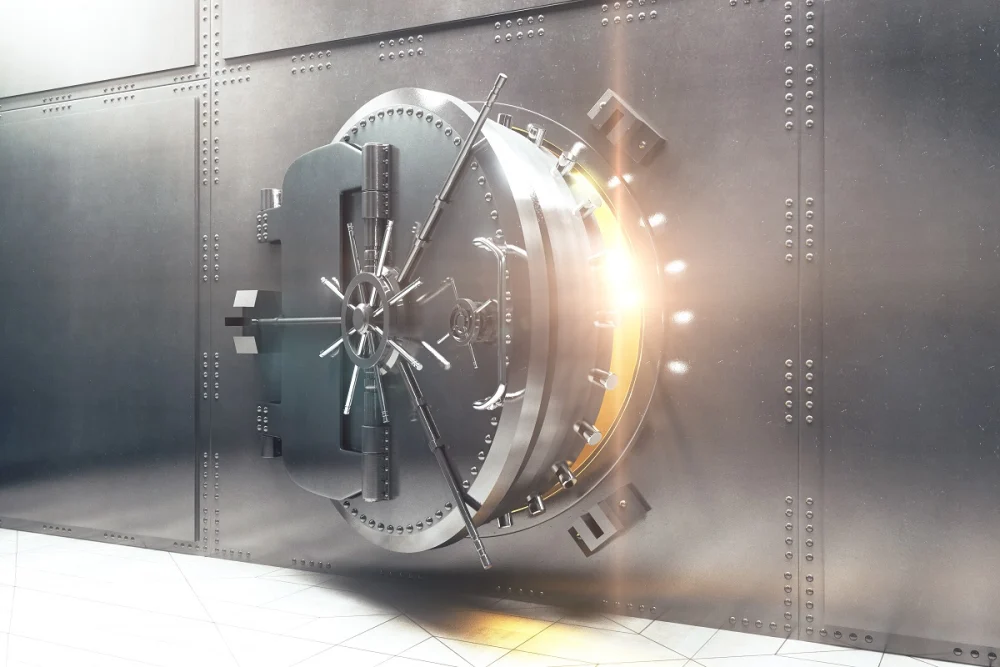 Heavy-duty steel bank vault door partially open with bright light shining through, representing physical banking security